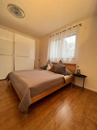 a bedroom with a large bed and a window at Ferienwohnung Natur in Balingen