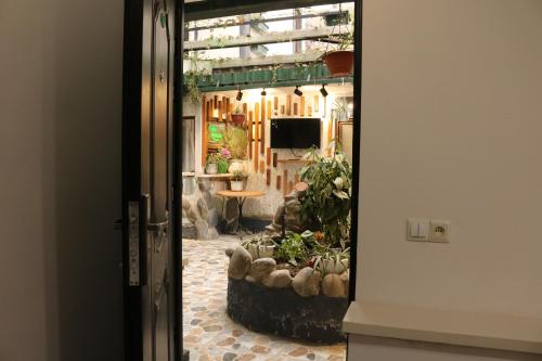 a view of a garden through a door at Kai Hotel Bar in Tbilisi City