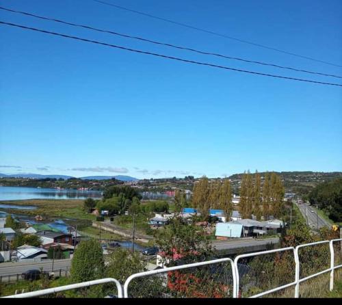 a view of a town with a river and a city at CABAÑAS QUELLON in Quellón
