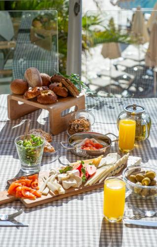 a picnic table with food and drinks and a box of orange juice at Dan Eilat Hotel in Eilat