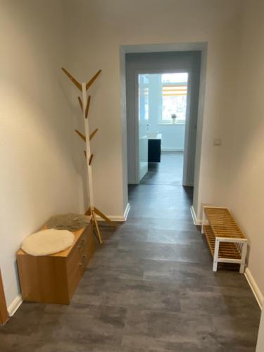 a hallway with a room with a plant and benches at Apartment im Grünen in Lichtenstein-Callnberg