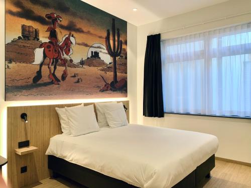 a bedroom with a bed with a painting on the wall at Comic Art Hotel in Ghent