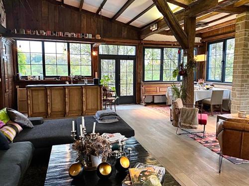 a living room with a couch and a table at La Maison Blanche de Martué in Florenville