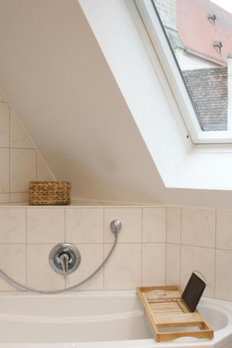 a skylight in a bathroom with a bath tub at American Ease Apartments - Hahnbach, Vilseck, Weiden in Hahnbach