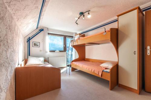 a bedroom with bunk beds in a small room at Holiday Chalet near Bled 