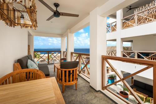 a living room with a view of the ocean at Bloozz resort Bonaire in Kralendijk