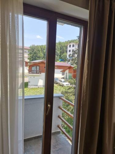 a sliding glass door with a view of a balcony at Orbi Palace Apartment in Bakuriani
