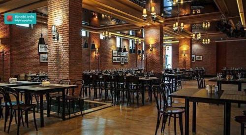 a restaurant with tables and chairs in a room at Orbi Palace Apartment in Bakuriani