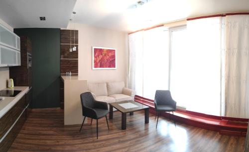 a living room with a couch and chairs and a table at Apartament Visit Ustroń in Ustroń