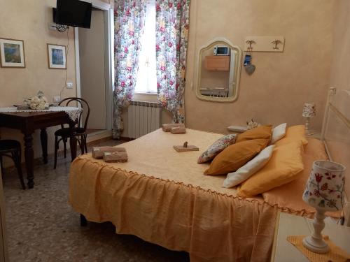 a bedroom with a bed with a table and a window at Affittacamere Da Carla in Bonassola