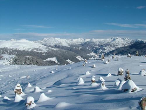 a group of people skiing down a snow covered mountain at Lingerhof Alpenrose in Meltina