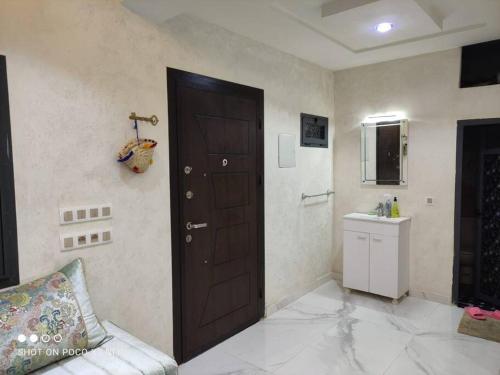 Cette chambre dispose d'une porte, d'un lavabo et d'un comptoir. dans l'établissement Super Chalet à Imouzzer kendar., à Imouzzer du Kandar