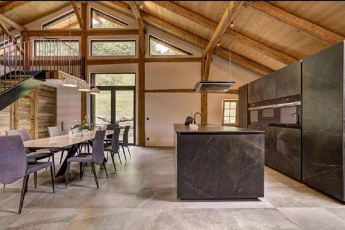 una cucina e una sala da pranzo con tavolo e sedie di Chalet de L'Ours Blanc a Saint-Gervais-les-Bains