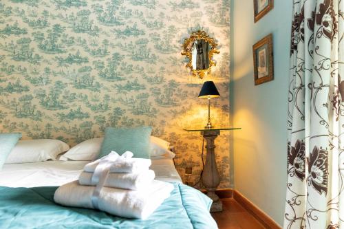 a bedroom with a bed with towels on it at Torre Di Vico Residenza D'Epoca in Viterbo
