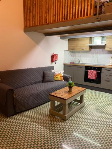 a living room with a couch and a coffee table at Ta Serafina studio apartment with loft in Għajnsielem