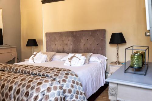 a bedroom with a large bed with two white pillows at Torre Di Vico Residenza D'Epoca in Viterbo