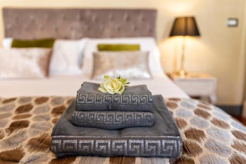 a pile of books sitting on top of a bed at Torre Di Vico Residenza D'Epoca in Viterbo