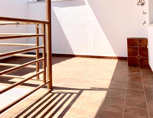 a room with a tiled floor and a staircase at Villa Rangel in Olivenza