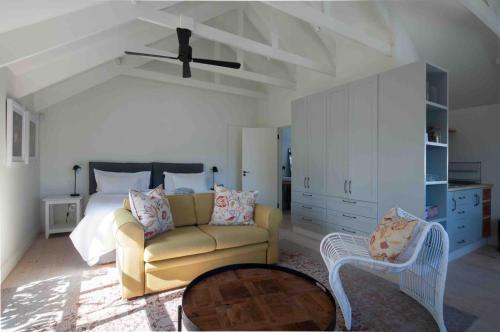a living room with a couch and a bed at African Flame Apartment in Knysna