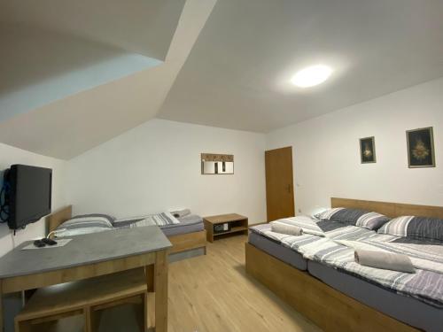 a room with two beds and a tv in it at APARTMA BRDO BC in Bovec
