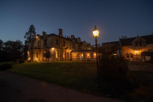 a house with a street light in front of it at night at Beechfield House in Beanacre