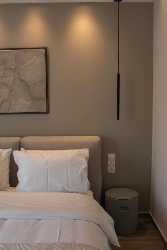 a bedroom with a bed and a painting on the wall at Langi Apartments in Mesolongion