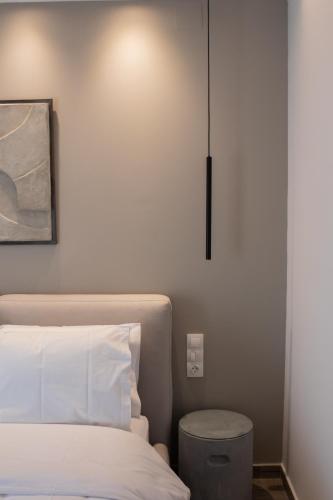 a bedroom with a bed and a light on the wall at Langi Apartments in Mesolongion
