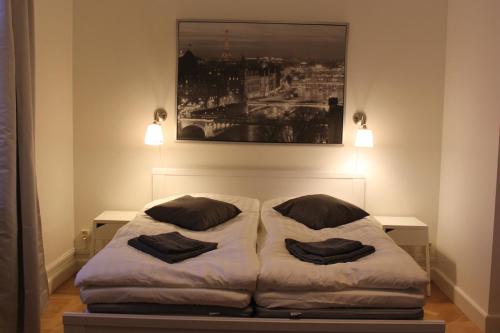 a bed in a room with two pillows on it at Vallarnas Bed & Breakfast in Falkenberg
