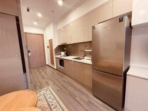 a large kitchen with a stainless steel refrigerator at NK#Homestay#Vinhomes#Oceanpark#1PN#C6 in Gia Lâm Pho