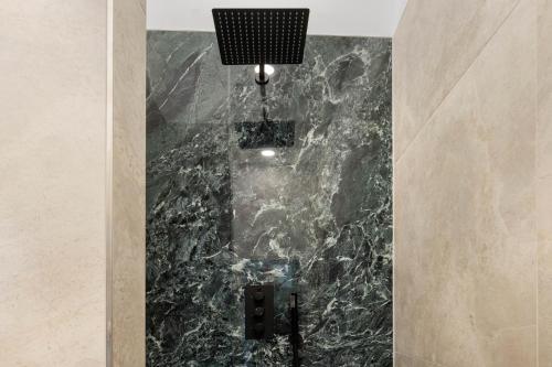 a marble shower in a bathroom with a light at NEW I LUXUS Suite I Kingbed I Center in Augsburg