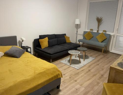 a living room with a bed and a couch at City Ela Center in Košice