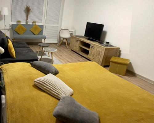 a living room with a bed and a tv at City Ela Center in Košice