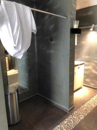 a bathroom with a shower with a white towel at Condo in a Private Resort setting King Maryout Alamriyah Governorate Egypt Comes with an outdoor private infinity swimming pool with a large garden Borg Alarb International Airport is 15 minutes in Alexandria