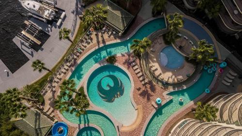 an overhead view of a swimming pool at a resort at Phoenix on the Bay 2 by Brett Robinson Vacations in Orange Beach