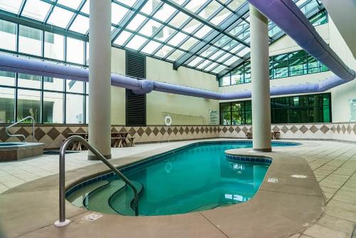 a swimming pool in a building with a glass ceiling at Phoenix on the Bay 2 by Brett Robinson Vacations in Orange Beach