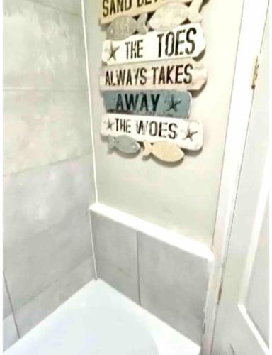 a bathroom with a toilet and a sign that says the toes always takes away at Rosa House in Darlington