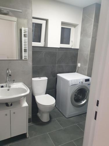 a bathroom with a washing machine and a washer at Apartmán Bambuľka in Slovenská ľupča