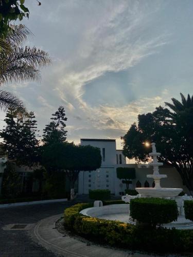 a building with a fountain in the middle of a park at Aldea del Bazar in Tehuacán