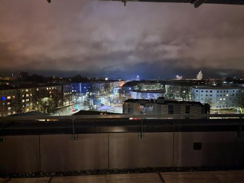 a view of a city at night at Artisa Riia Str 20a Luxury 2BR Penthouse Apartment in Tartu