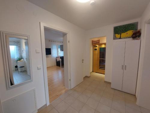 a living room with white walls and a hallway at Ferienwohnungen Apart Diana in Vils