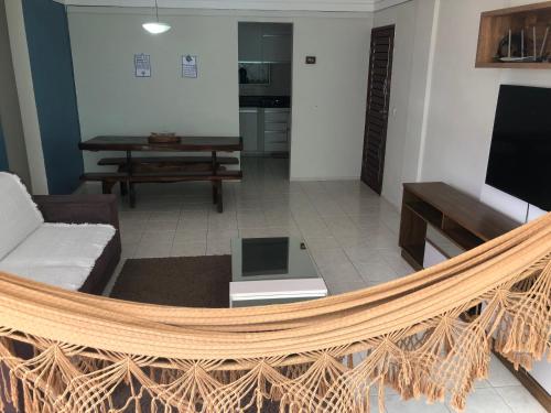 a living room with a hammock in the middle at Verão on in Cabedelo