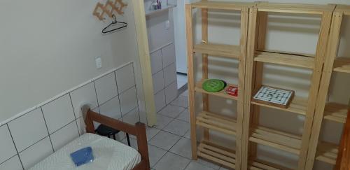 a small room with a chair and a cabinet at Aconchego em Floripa in Florianópolis