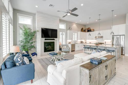 a living room with white furniture and a kitchen at Waterfront Paradise, Private Pool & Dock, Poolside TV & Multi-TV Game Room in Rockport