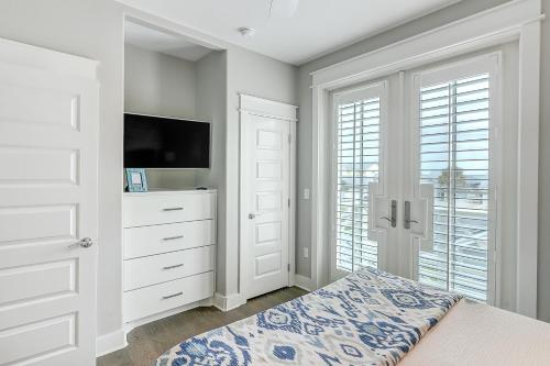 a white bedroom with a dresser and a tv at Waterfront Paradise, Private Pool & Dock, Poolside TV & Multi-TV Game Room in Rockport