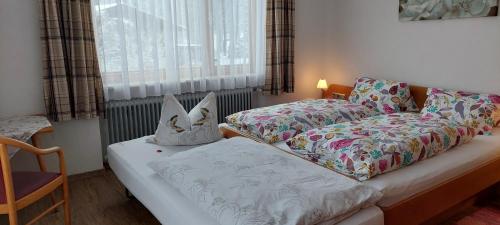 a bedroom with a bed and a bed and a window at Pension Wildental in Sankt Martin bei Lofer