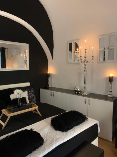 a bedroom with a bed and a table and a mirror at Apartment Capital in Maribor