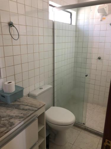 a bathroom with a toilet and a shower at Verão on in Cabedelo