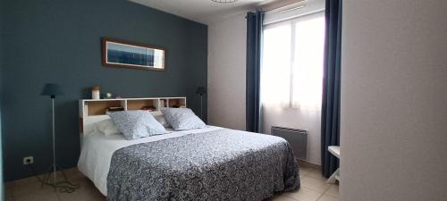Schlafzimmer mit einem Bett und einem Fenster in der Unterkunft Apppartement 2 pièces centre-ville in Chauffailles