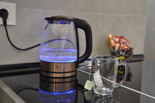 a jug of water sitting on a counter next to a glass at Mali Princ Pupin Palace in Novi Sad