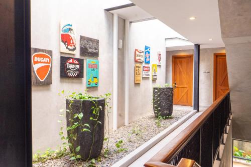 a hallway with potted plants on the side of a building at Hotel Summerville in Majalengka